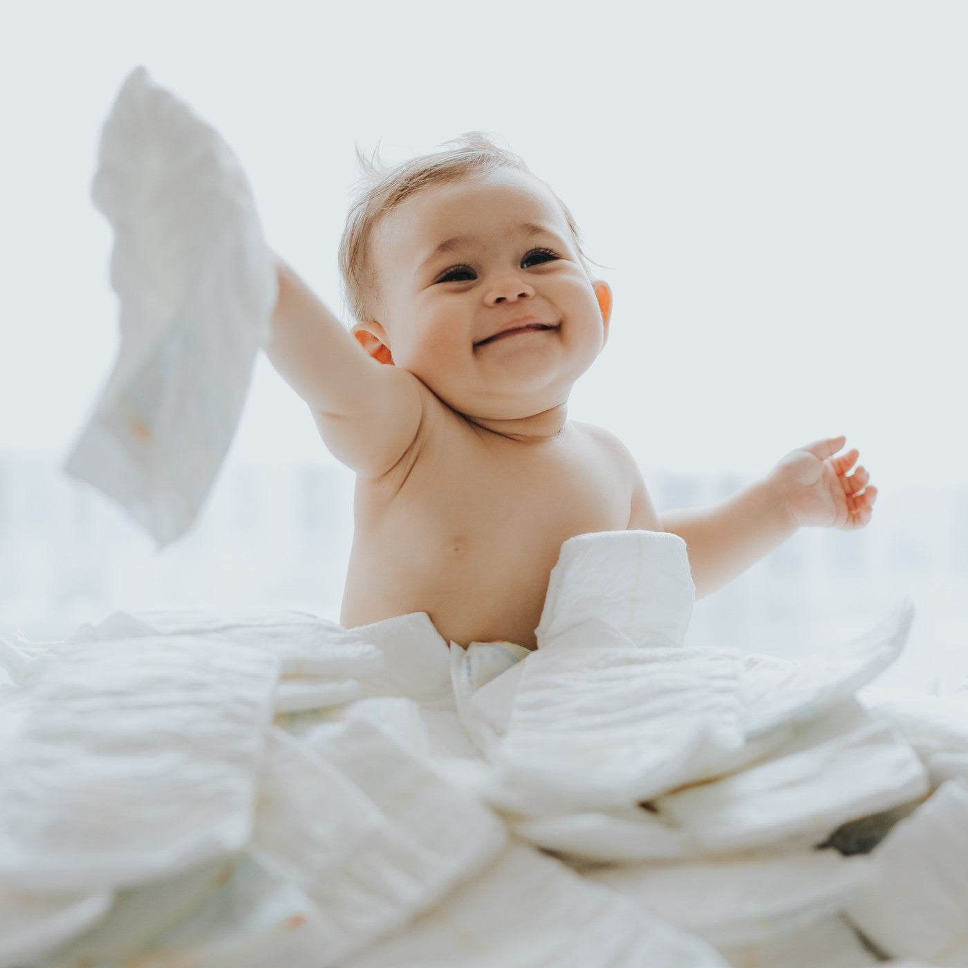 baby is playing on diapers