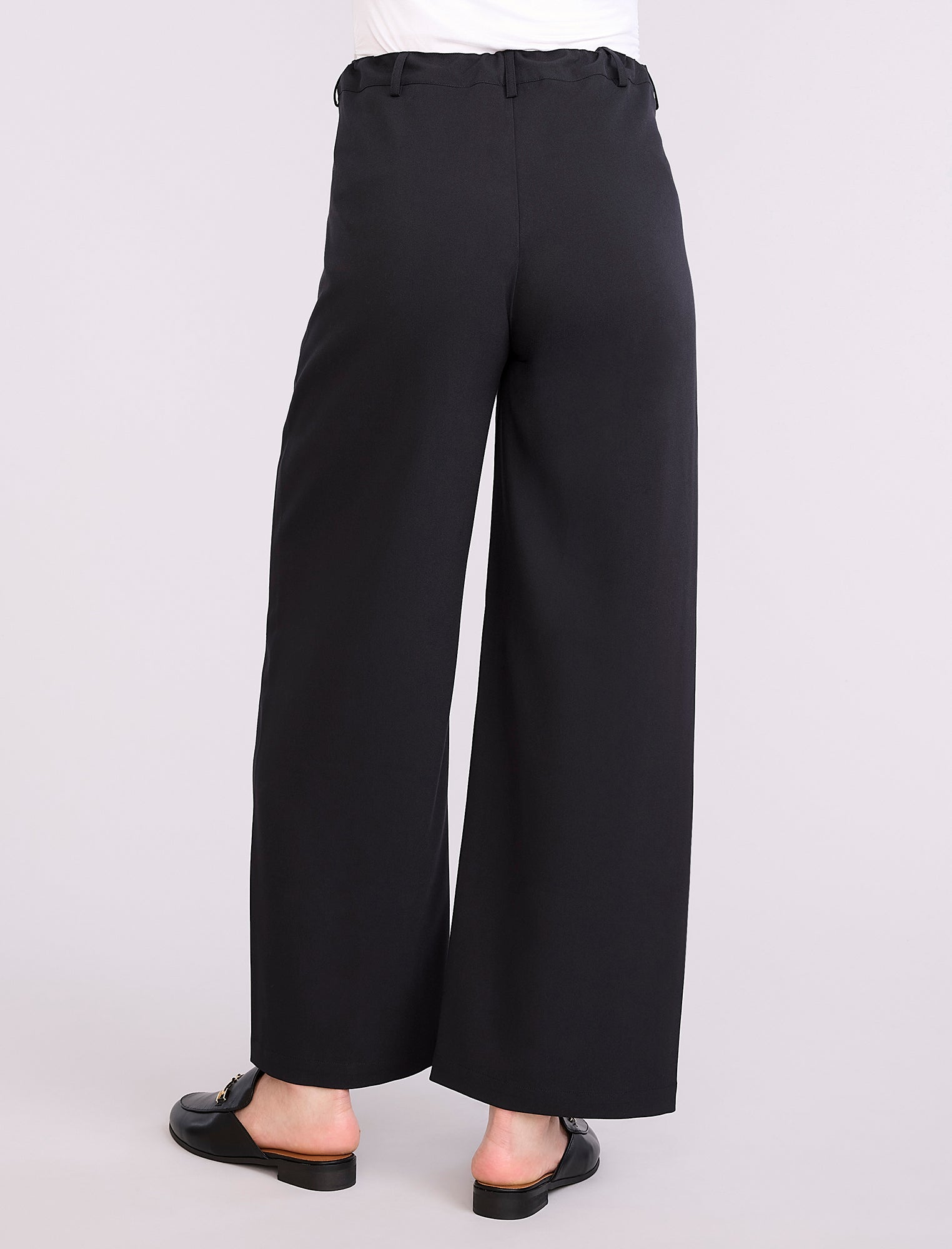 Black wide-leg maternity pants worn by a person on a white background