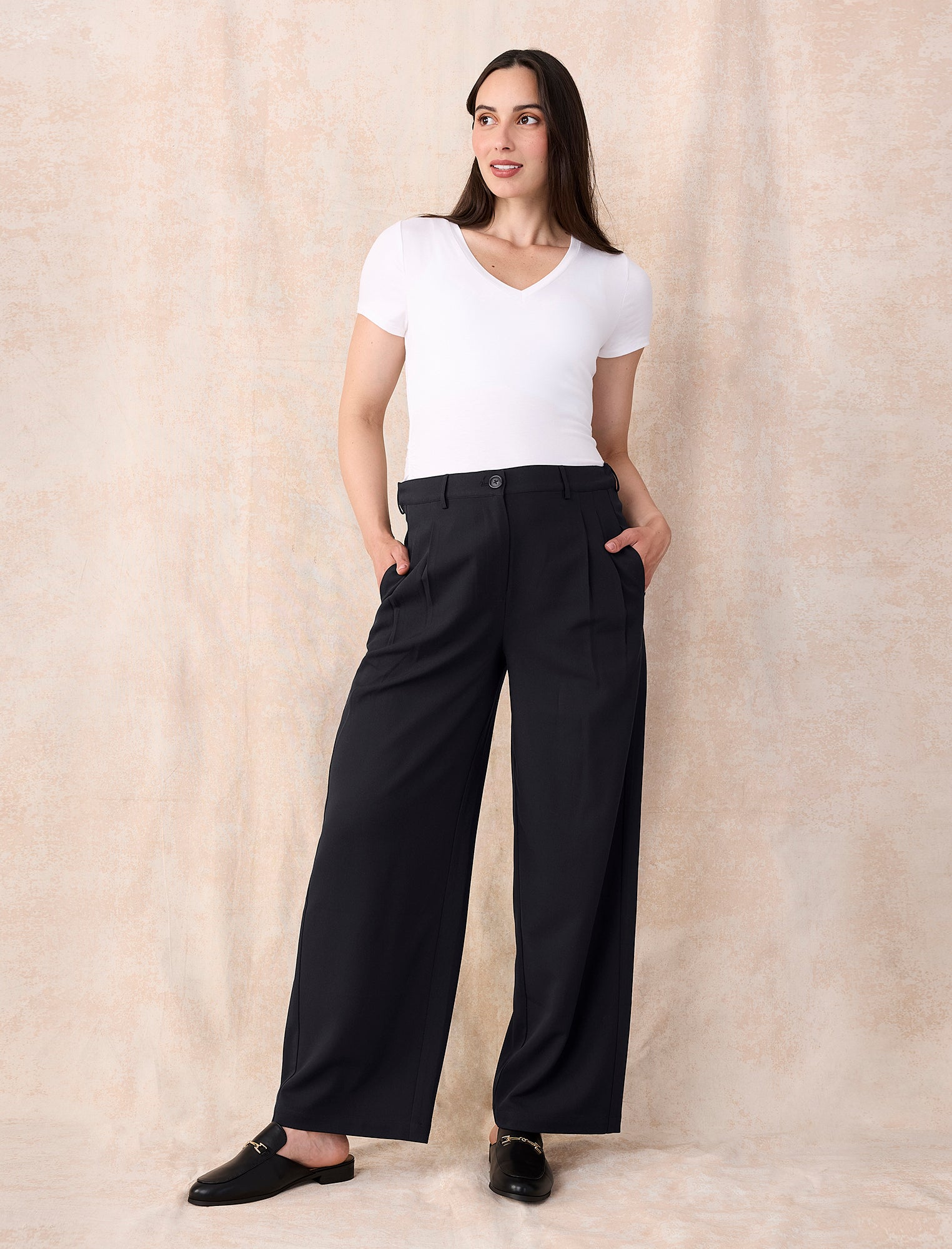 White maternity t-shirt and black wide-leg maternity pants worn by a person on a white background