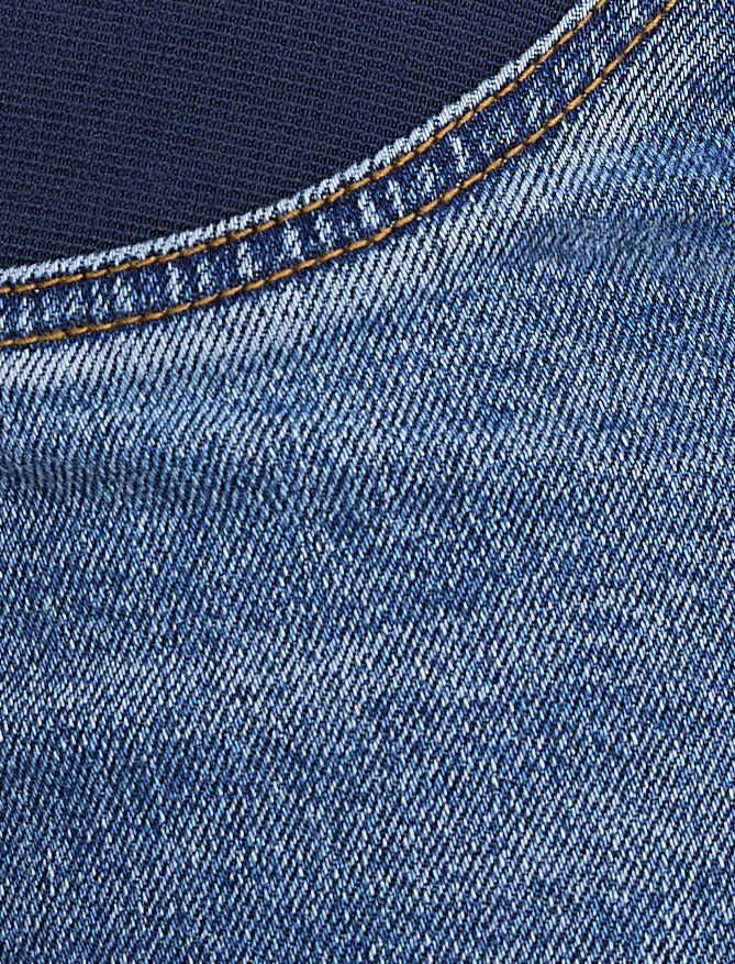Close-up of blue denim fabric with stitching detail