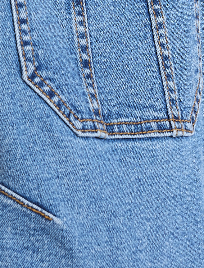 Close-up of blue denim fabric with stitching detail