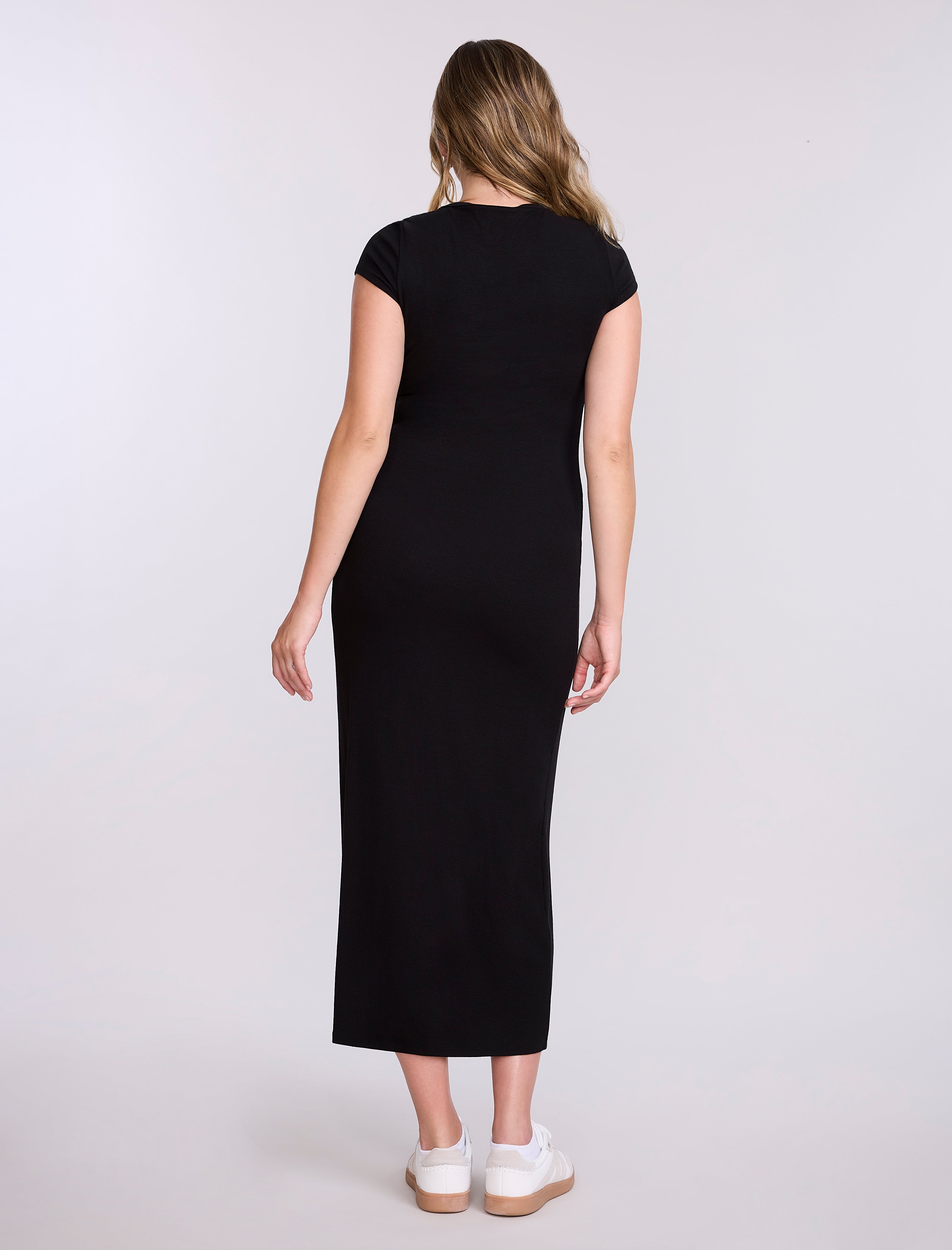 Woman wearing a black dress on a white background