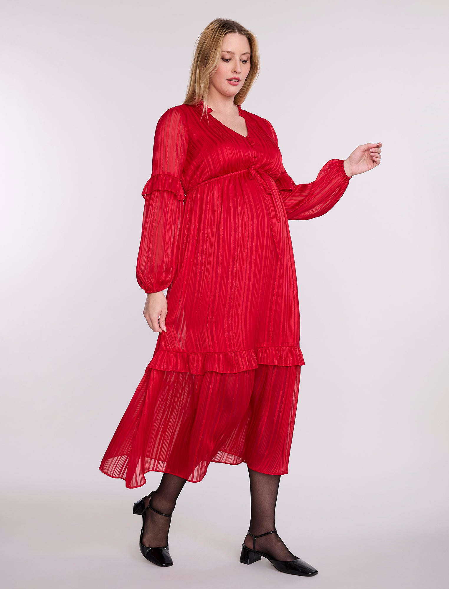 Pregnant woman wearing a red dress on a white background