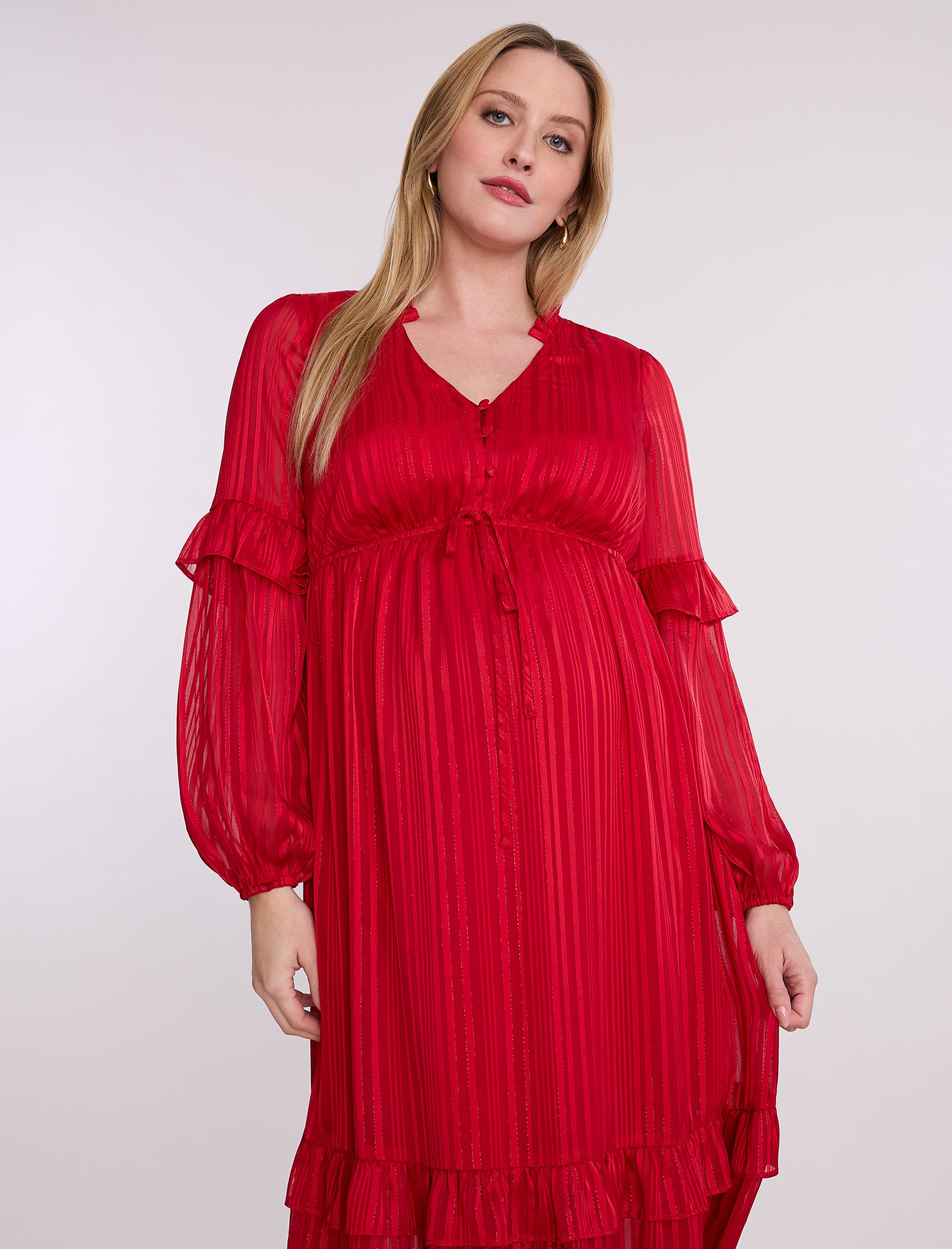 Pregnant woman wearing a red dress on a white background