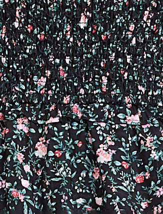 Floral patterned fabric with pink and green flowers on a black background