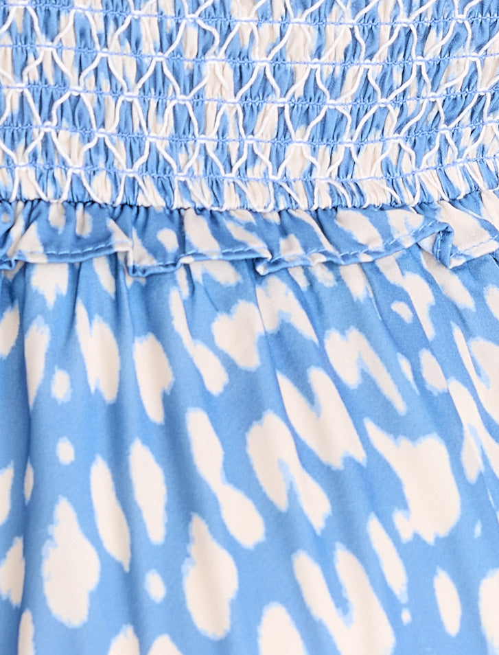 Blue and white patterned fabric with ruffled edge
