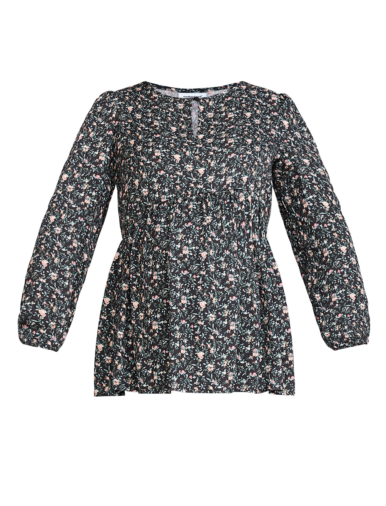 Pregnant woman wearing a black floral blouse against a plain background